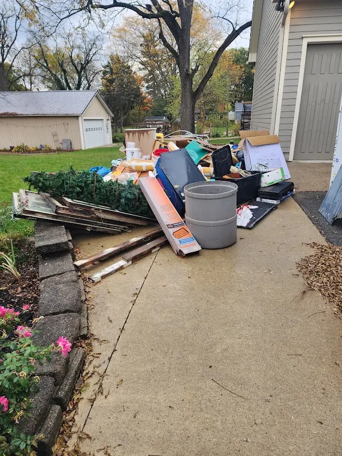 Dumpster being loaded with debris for 12 Yard Dumpster Rental in North Baltimore